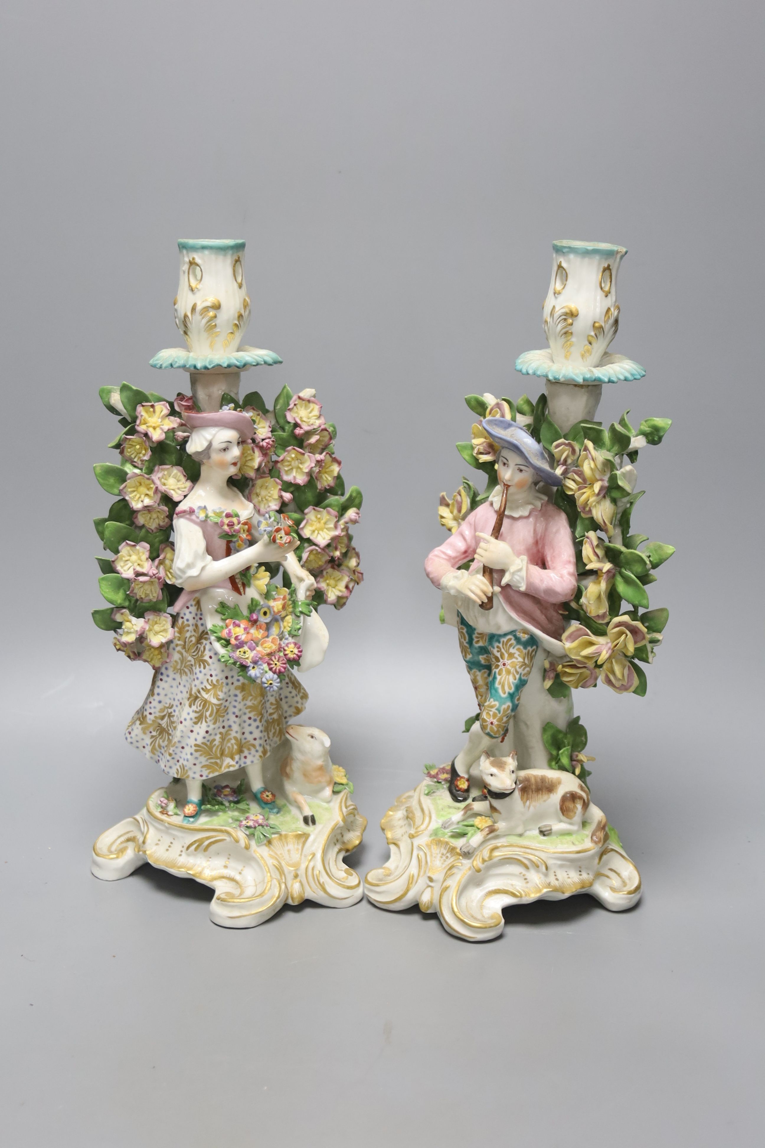 A pair of Derby style candlestick figures, height 27cm